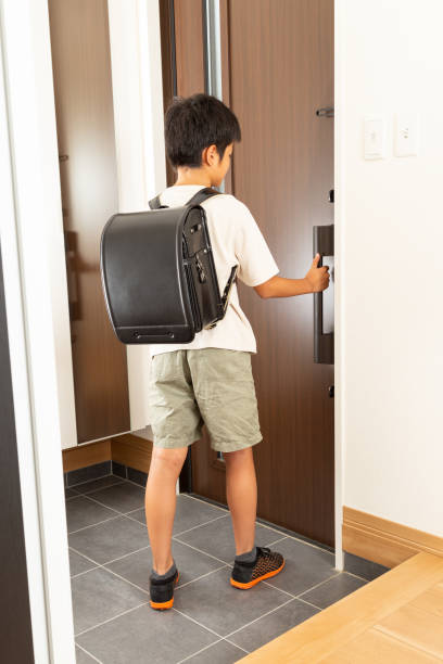 istock A boy opens the front door and leaves. 1694949357