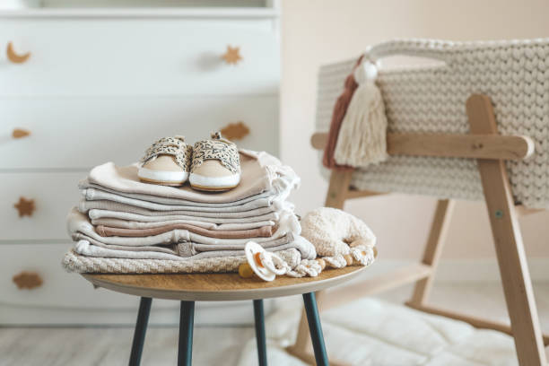 istock A stack of children's things on a wooden table in a children's interior 1694956688