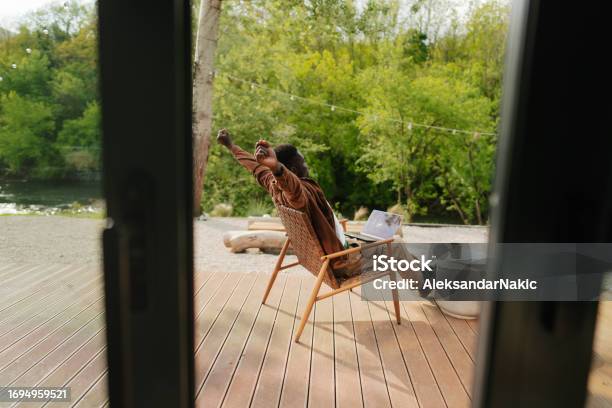 Working Remotely From The Log Cabin On The Riverbank Stock Photo - Download Image Now