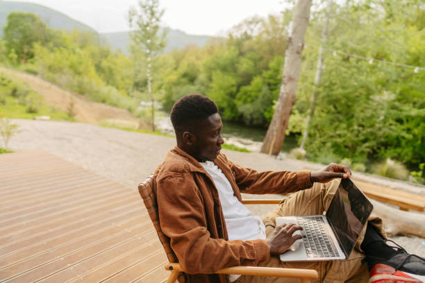 istock Working remotely from the log cabin on the riverbank 1694960666