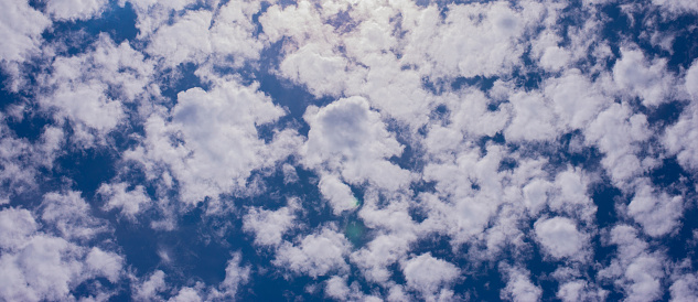 a group of white clouds in the sky with a dark blue background