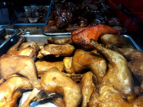 Photo of On the window of the restaurant are Hong Kong's famous roast goose, duck and pork sausages and chicken legs. Shooting through the glass