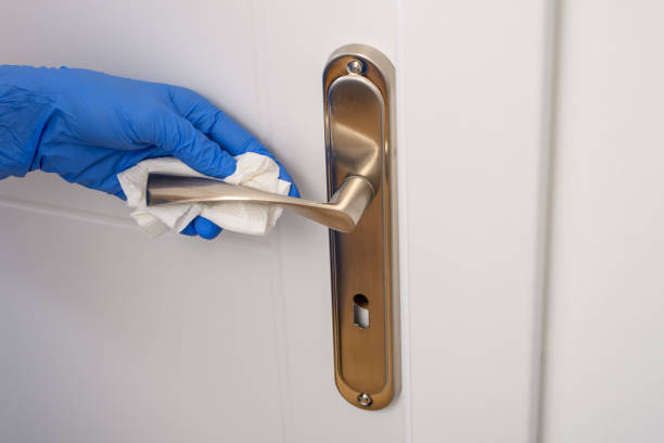 istock Door handle wiped with a cloth, disinfection 1694971665