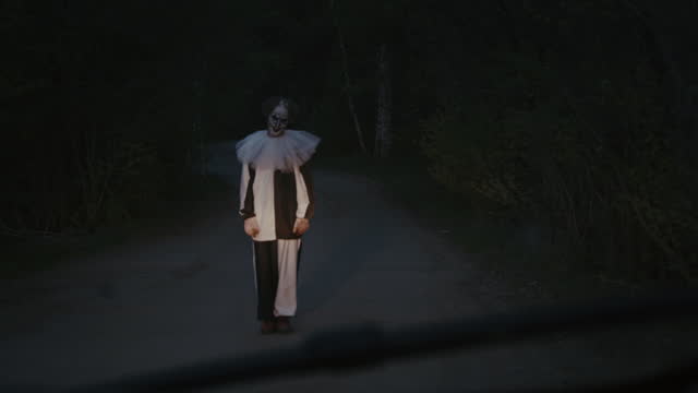 Viewer Seeing Scary Clown Standing in Middle of Road from Car Window