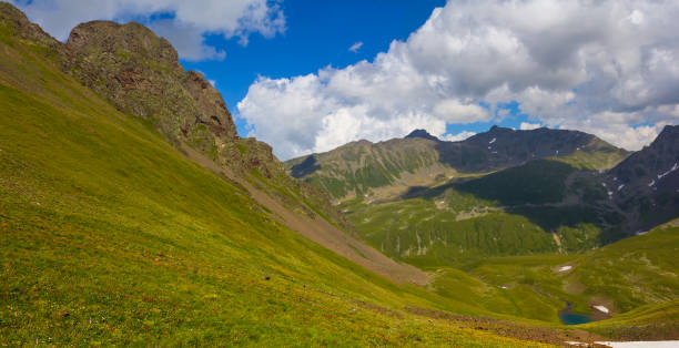 istock green mountain valley under blue cloudy sky 1694975617