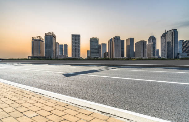 istock empty asphalt road with city skyline background in china 1694984266