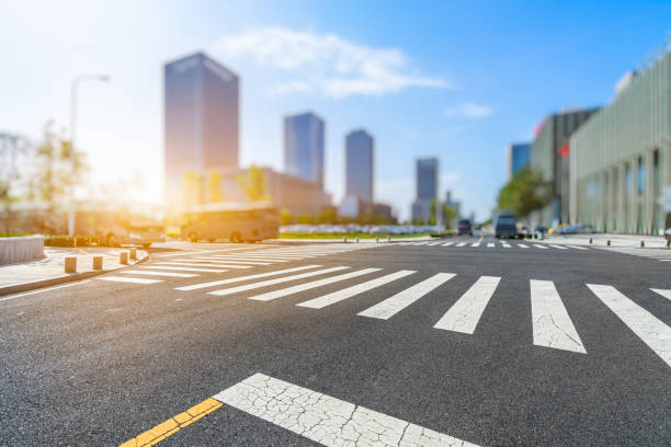 istock empty road with zebra crossing and skyscrapers in modern city 1694985982