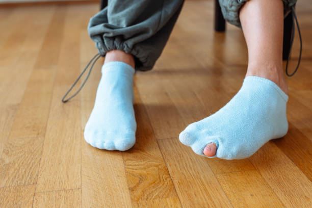 istock holey sock on teenager's foot 1694991715