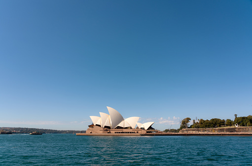 Sydney Australia - August 29, 2023: A bright winter's day in Sydney, New South Wales, and this is the view looking across Sydney Harbour towards the city's iconic Opera House.