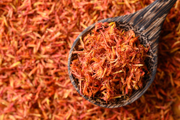 istock Dried safflower in spoon, Herbal tea 1695023817