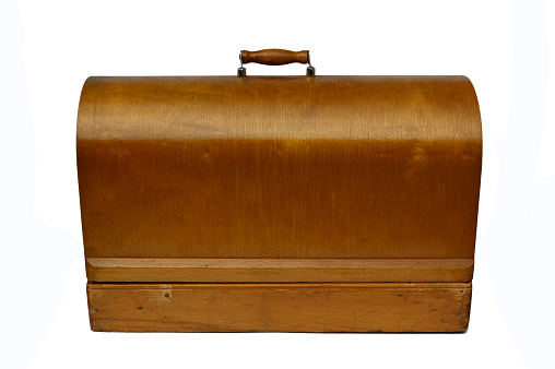 wooden case of an old vintage sewing machine on white background