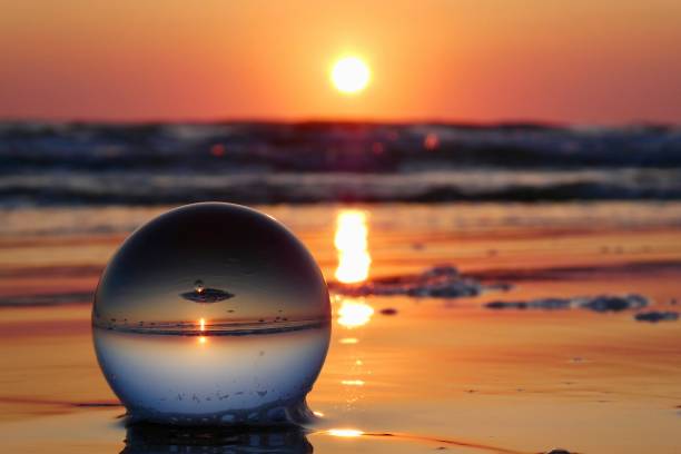 istock Crystal ball at beach during dawn 1695038736