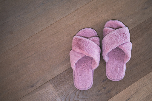 Pink slippers on the wooden floor