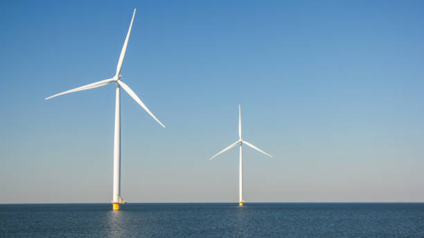istock offshore windmill park with clouds and a blue sky, wind mill turbines in the Netherlands 1695073294