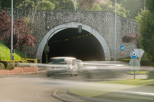 A road tunnel in an urban area with traffic in blurred motion