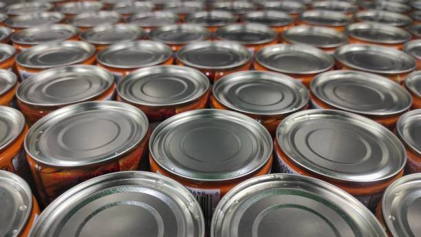 istock Industrial background of silver metal can in conveyor machine before packing process 1695104806