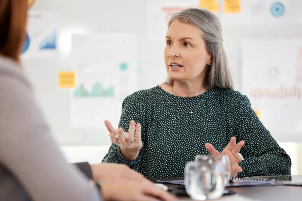 istock Manager, coaching and training team, communication and presentation in marketing and advertising company table. Mature woman, mentor and planning a strategy,  managementor working in startup business 1695109372