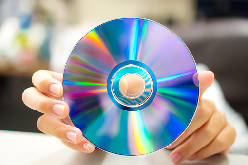 Image of the back of a blue DVD disc used for storing multimedia content including movies, music, and data.