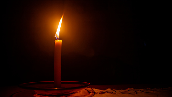 candles, grouped together on dark background.