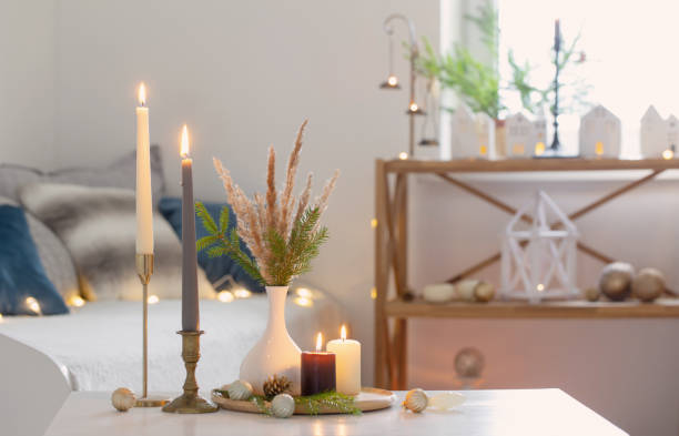 istock burning candles with christmas decor in white cozy interior 1695149937