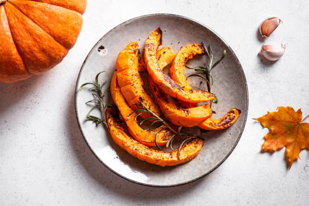 istock Roasted pumpkin slices with garlic and herbs 1695156745