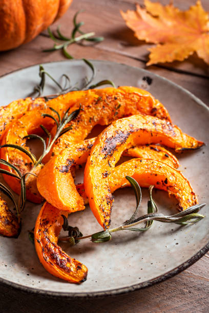 istock Roasted pumpkin slices with garlic and herbs 1695157902