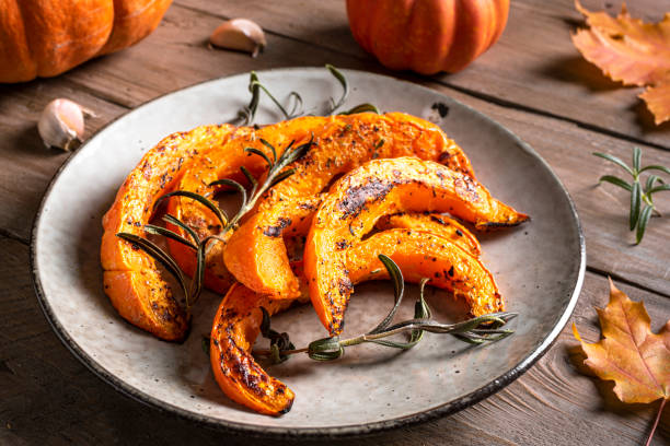 istock Roasted pumpkin slices with garlic and herbs 1695158440