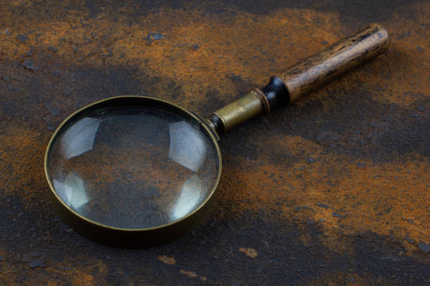 istock Vintage magnifying glass on metal rusty background, 1695160243