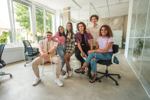 Tomorrow's leaders stand together in unity as Gen Z professionals capture their shared vision in a group photo. The inclusivity is clear, with a radiant non binary member gracing the center.