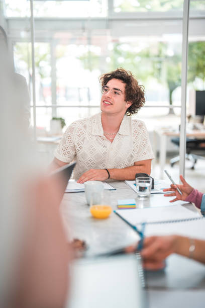 istock Gen Z Male Actively Contributing in Office Meeting 1695161729