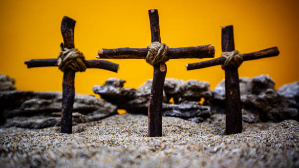 istock crosses stuck in the sand on an orange background 1695163570