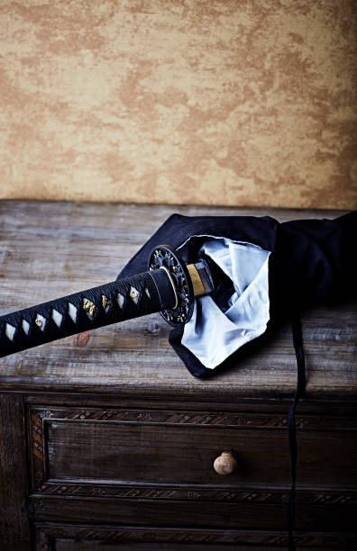 istock Wakizashi Sword on an old retro-style cabinet. Soft focus. copy space. 1695170317