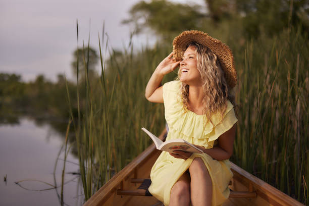 istock Happy woman enjoying during spring day in a canoe. 1695182007