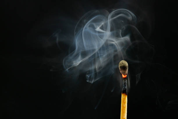 Matchsticks burned in the dark background.