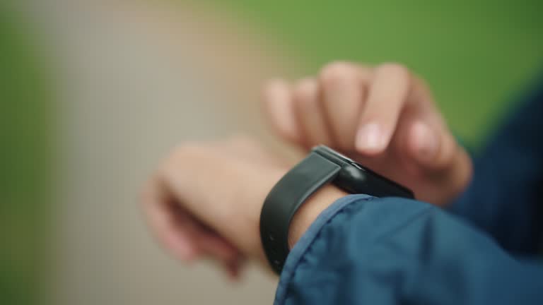 Man using smartwatch while exercise at park.