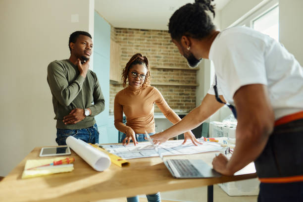 istock African American couple talking to manual worker during renovation process. 1695199182