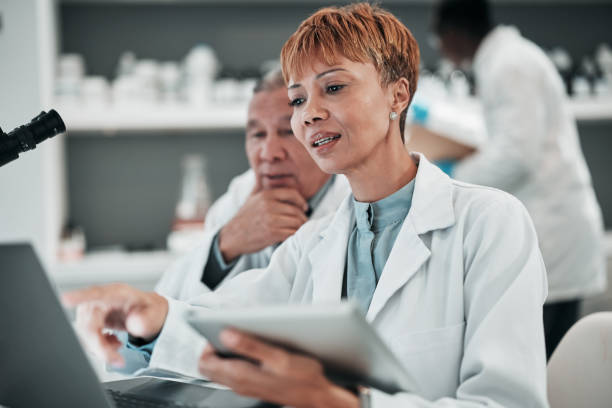 istock Science, teamwork and discussion on laptop in laboratory to research solution, investigation and review medical data. Scientist, woman and planning digital results, biotechnology and info on computer 1695209793