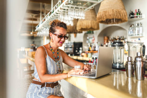 istock Adult woman working remotely on vacation 1695212020