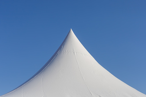 top of a pointy white tent