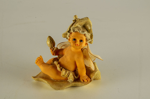 Close-up of child angel statuette Object on a White Background