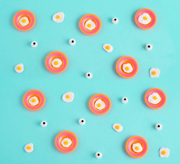 istock Top view flat lay miniature fried eggs and coffee cups on pastel blue background. 1695262374