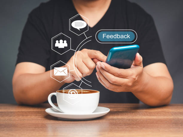 istock Young man using a smartphone to give feedback via the internet while sitting at the table in the office 1695271097