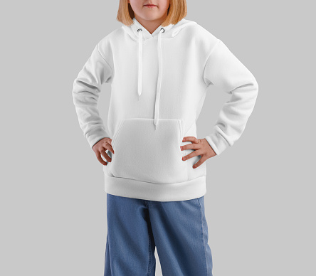 Mockup of a white hoodie on a fair-haired girl in jeans, front view, kid's clothes with a pocket, ties. Long sleeve template with hood for design, pattern, isolated on background. Product photography