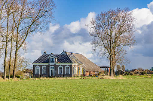 Gaaikemadijk, The Netherlands - March 27, 2023: Large manor Farm house along Gaaikemadijk municipallity Westerkwartier Groningen province The Netherlands