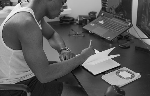 Man taking notes on desk