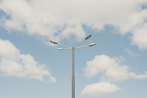 Street lamp against the blue summer sky