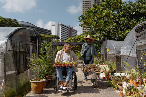 Asian urban farmers moving between greenhouses in the urban farm