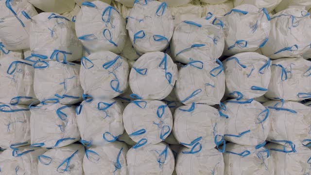 [Z05] Aerial view of warehouse - stocks of large sacks (big bags) waiting for delivery - slow motion