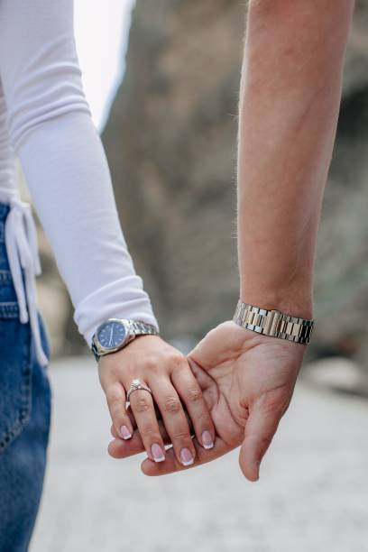 istock Couple showcasing a woman's engagement ring. 1695316959