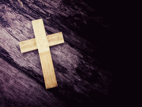 Lent Season,Holy Week and Good Friday Concepts - wooden cross with purple vintage background. Stock photo.